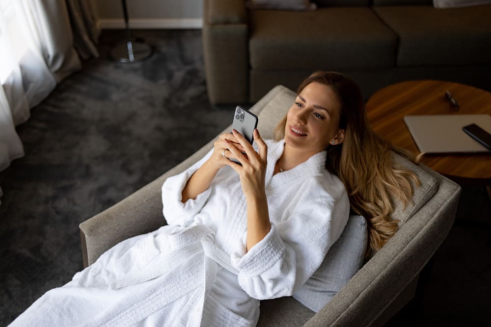 Woman at a spa on her phone learning about med spa marketing strategies